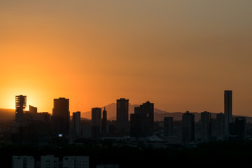 Fototapeta na wymiar Sunset over city silhouette with clear sky
