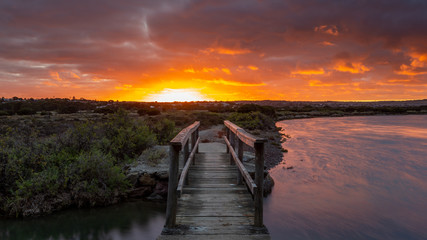 Sunrise over the small foot bridge located on the Onkaparinga River in Port Noarlunga South Australia on 30th March 2020