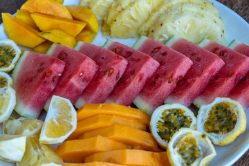 Tropical fruits on a breakfast plate, close up