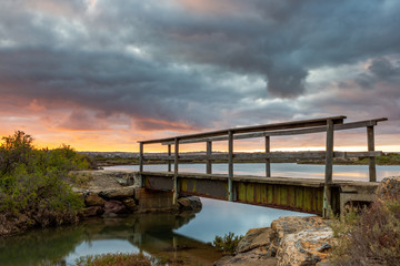 Sunrise over the small foot bridge located on the Onkaparinga River in Port Noarlunga South Australia on 30th March 2020
