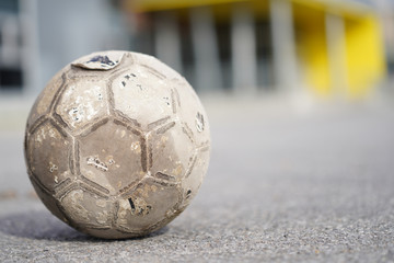 Fototapeta na wymiar Old Soccer ball in field