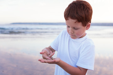 happy young boy on the beach