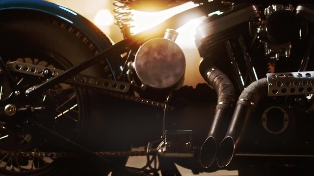 Custom Bobber Motorbike Standing in an Authentic Creative Workshop. Vintage Style Motorcycle Under Warm Lamp Light in a Garage. Close Up View.