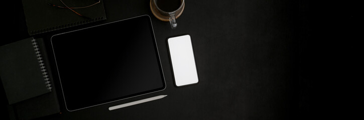 Overhead shot of dark concept workplace with mock-up smartphone on black table