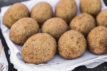 Close up photo of croquette cake at a street food market fair festival