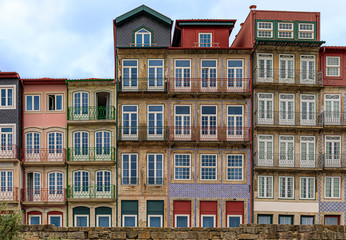 Traditional house facades decorated with Portuguese azulejo tiles in the famous Ribeira neighborhood in Porto, Portugal