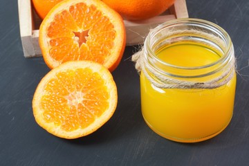 Naklejka na ściany i meble Fresh orange juice and citrus fruits on a simple table