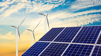 Solar panels with wind turbines in the setting sun,green energy.