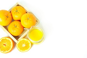 Fresh orange juice and citrus fruits on a simple table
