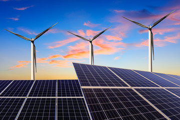 Solar panels with wind turbines in the setting sun,green energy.