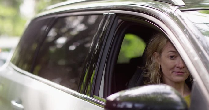 4K Female driver trying to make excuses to policeman for traffic violation. Slow motion.