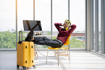 summer concept.Company employees prepare for weekend travel. Young asian businessman preparing for vacation in the office.