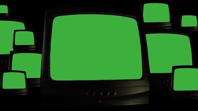 Multiple vintage televisions on black background, repeating pattern of many retro TVs with green screen chroma key and noise interference. TVs of 80s, old retro televisions with bad signal reception