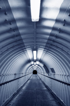 Naklejki Empty pedestrian tunnel at night. Architecture abstract background