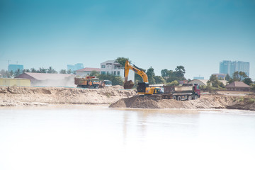 An excavator digs sand. Bulldozer at a construction site.