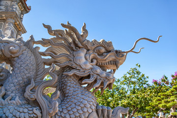 Naklejka premium A dragon statue by entrance gate at Linh Ung Pagoda in Da Nang, Vietnam