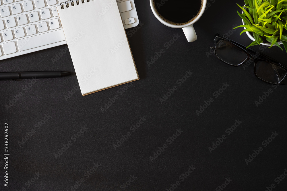 Aufkleber workplace office with dark black desk. top view from above of keyboard with notepad and coffee cup. 
