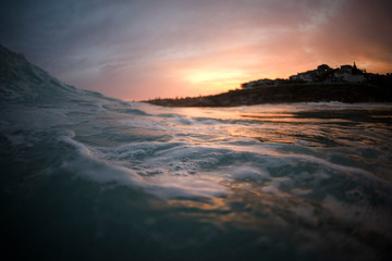 Fototapeta na wymiar Splashing waves at sunset, Tamarama Beach, Australia