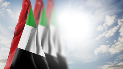 Close up waving flag of United Arab Emirates. National United Arab Emirates flag in the sky.