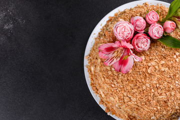 Fresh delicious cake napoleon with cream on a dark background