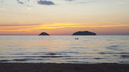 Naklejka na ściany i meble Bright and beautiful sunset on the sea taking from the phone