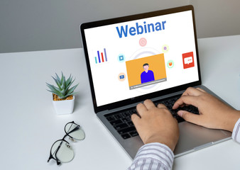 Person using a laptop computer for online training webinars. E-learning browsing connection and cloud online technology webcast concept. Laptop mockup with clipping path on screen.