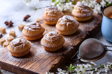 Fresh baked cupcakes of rice flour with banana and vanilla with a mug of hot chocolate