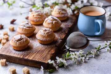 Fresh baked cupcakes of rice flour with banana and vanilla with a mug of hot chocolate