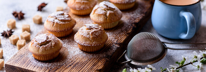 Fresh baked cupcakes of rice flour with banana and vanilla with a mug of hot chocolate