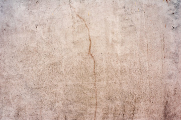 Fototapeta premium Texture of a concrete wall with cracks and scratches which can be used as a background