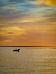 Naklejka na ściany i meble Boat on sea at sunrise. Morning seascape.