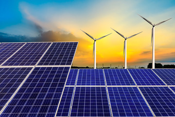 Solar panels with wind turbines in the setting sun,green energy.