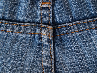 Close-up of jeans background with seams. Back seam of jeans Fabric backdrop with stitches