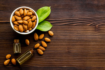 Spa and aromatherapy. Almond oil in small bottles on wooden background top-down copy space