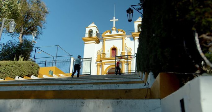 Grandfather and child climbing the steps to Iglesia del Cerro de Guadalupe