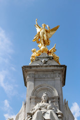 Gilded Winged Victory at the top of the Victoria Memorial in front of Buckingham Palace in a sunny...