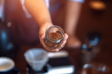 Fototapeta na wymiar Barista show coffee beans in drip glass.