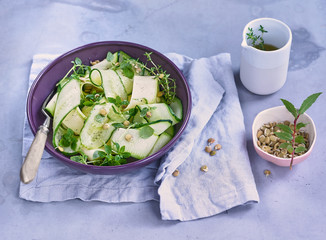 fresh salad of cucumbers and herbs on a plate