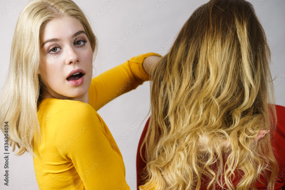 Poster Two girls creating hairdo. Hair ombre color