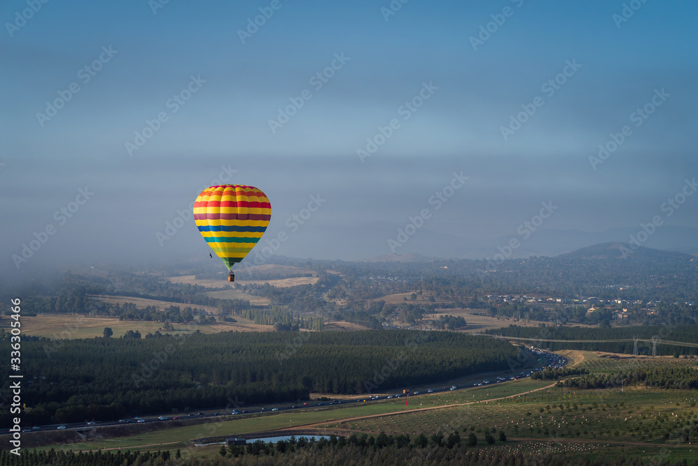 Wall mural Hot Air Balloon flying high above the countryside in Canberra, Australia - Wall murals