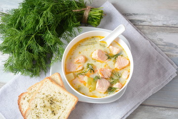 Creamy fish soup with salmon, potatoes, onions , carrots, dill and celery . Kalakeitto-traditional dish of the Finnish cuisine or Russian Ukha Fish Head Soup. Healthy Food Concept. Omega-3