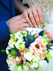 Hands of the newlyweds with rings, wedding bouquet. Russia. Russian tradition. Ural