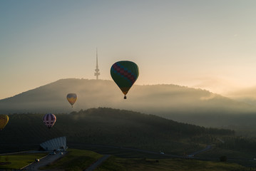 Hot Air Balloon flying high above the countryside in Canberra, Australia - obrazy, fototapety, plakaty