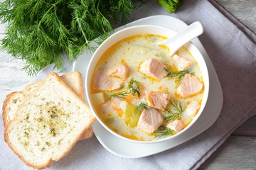 Creamy fish soup with salmon, potatoes, onions , carrots, dill and celery . Kalakeitto-traditional dish of the Finnish cuisine or Russian Ukha Fish Head Soup. Healthy Food Concept. Omega-3