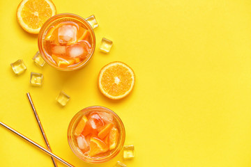 Glasses of tasty cold ice tea on color background