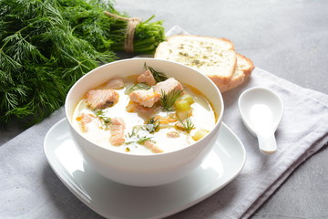 Creamy fish soup with salmon, potatoes, onions , carrots, dill and celery . Kalakeitto-traditional dish of the Finnish cuisine or Russian Ukha Fish Head Soup. Healthy Food Concept. Omega-3