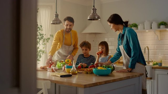 In Kitchen: Family of Four Cooking Together Healthy Dinner