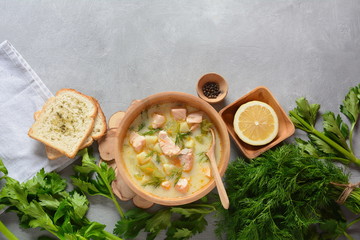 Creamy fish soup with salmon, potatoes, onions , carrots, dill and celery . Kalakeitto-traditional dish of the Finnish cuisine or Russian Ukha Fish Head Soup. Healthy Food Concept. Omega-3