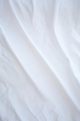 Obraz premium Blurred white bedsheet drying in the sun, Wrinkled texture, Abstract background, Close up shot, Selective focus, Housework, Laundry concept