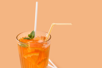 Glass of tasty cold ice tea on color background